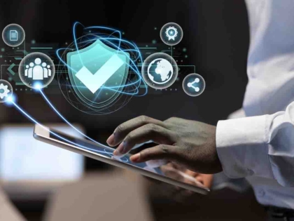 Female blogger with laptop recording video while sitting at offi