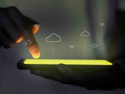 Female blogger with laptop recording video while sitting at offi