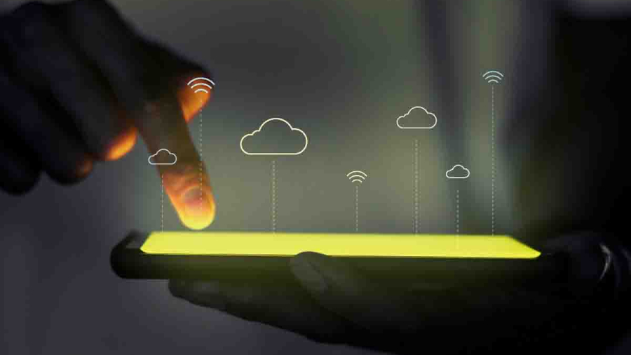 Female blogger with laptop recording video while sitting at offi