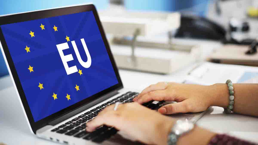 Female blogger with laptop recording video while sitting at offi